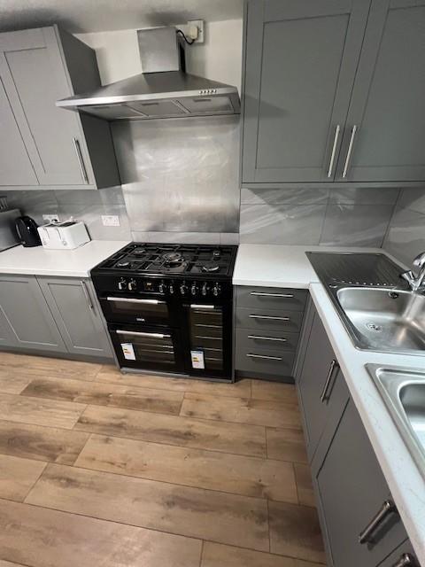 Modern fitted kitchen with sleek grey cabinetry...