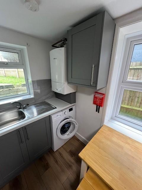 Bright, modern kitchen with grey cabinetry, int...