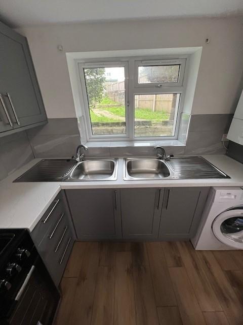 Modern galley kitchen with dual stainless-steel...