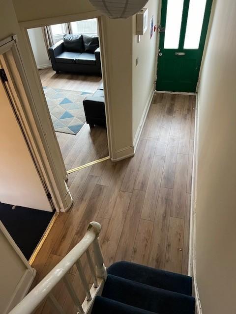 Bright, welcoming hallway with wood-effect floo...