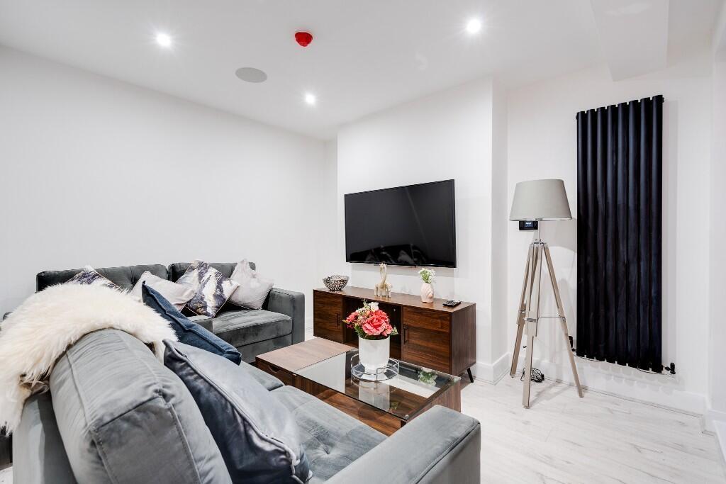 A modern, spacious living room featuring comfor...