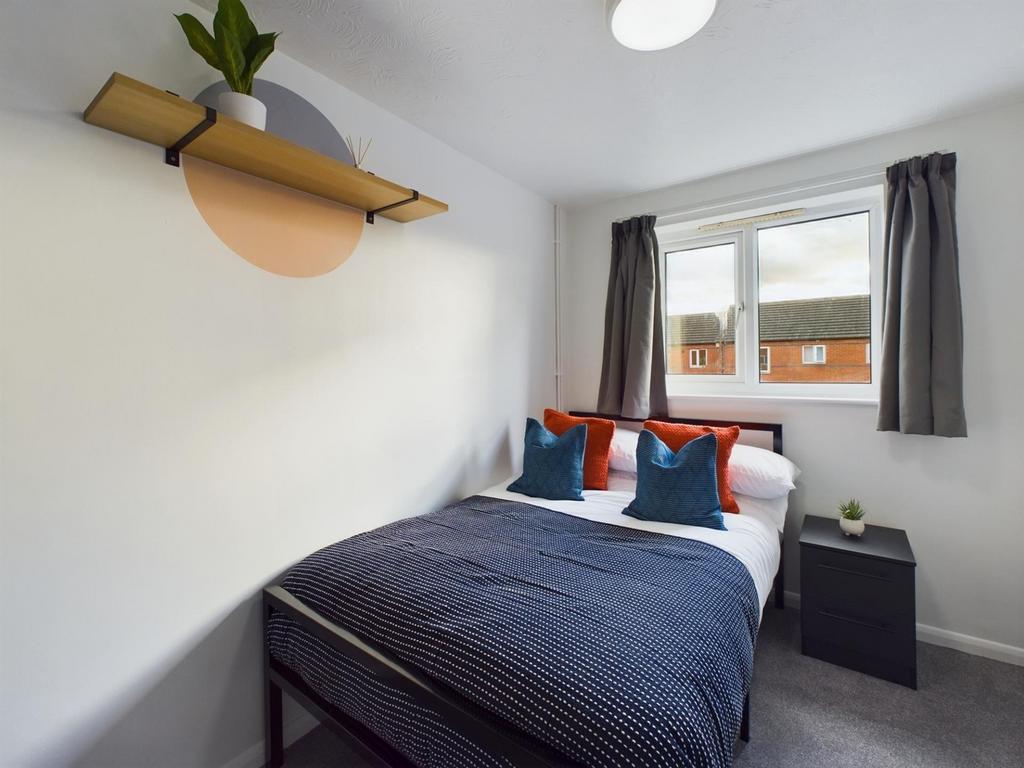 A bright and inviting double bedroom featuring ...