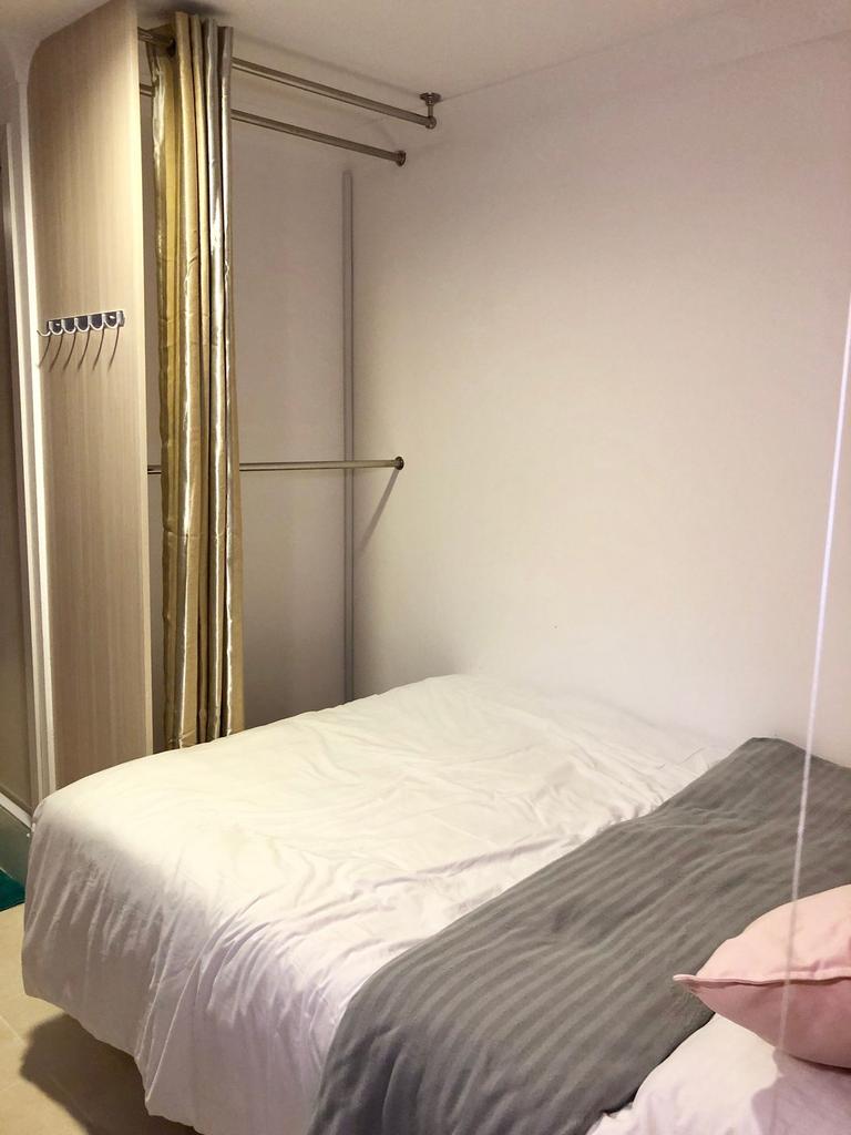 Cozy bedroom with a neatly made double bed, neu...