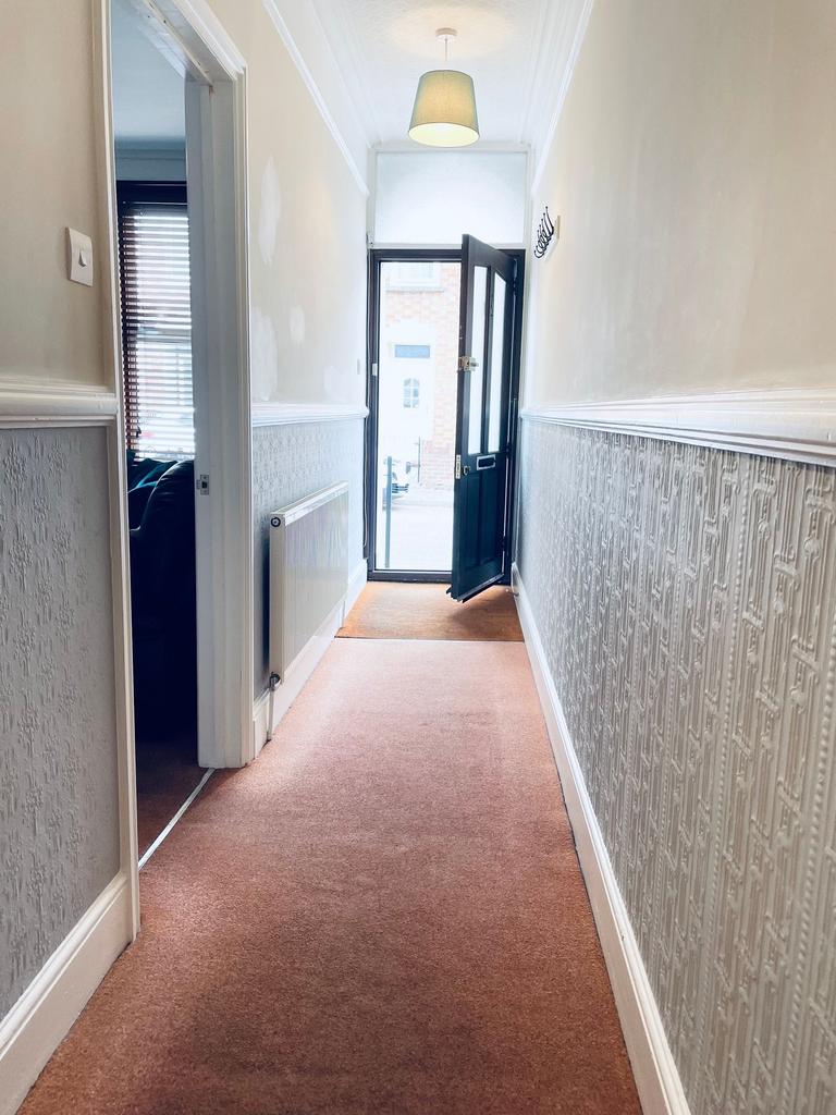 Bright, well-kept hallway with textured panelli...