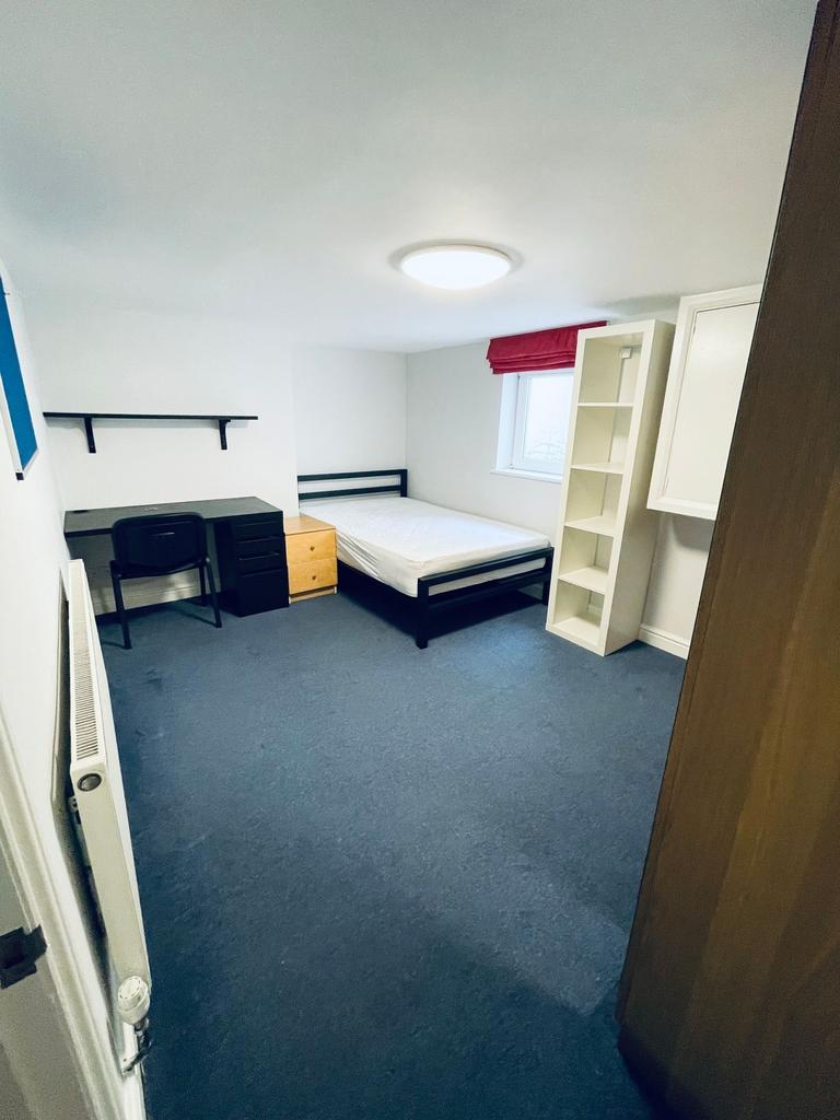 Bright, simply furnished bedroom with a single ...