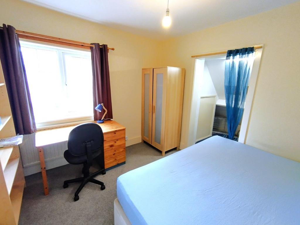 Bright, neatly presented bedroom with a large w...