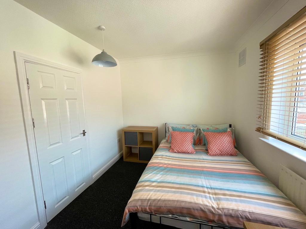 Bright, neatly presented bedroom with a double ...