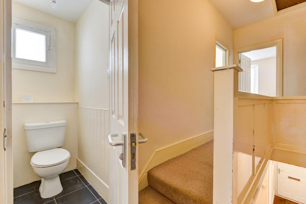 A clean and bright bathroom featuring a toilet ...