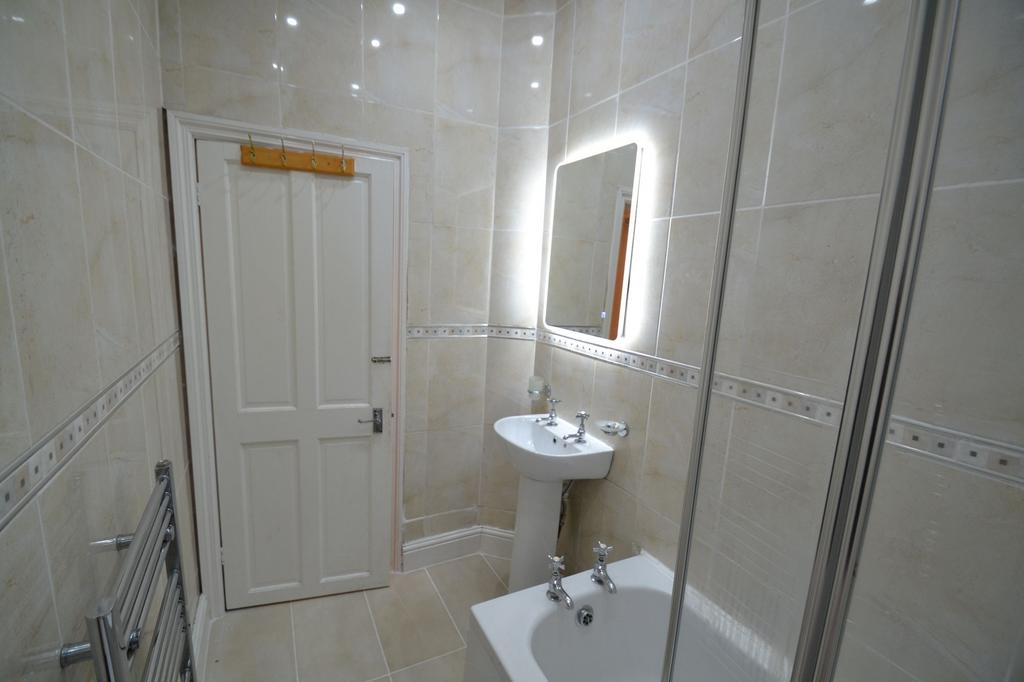 Bright and clean bathroom featuring a modern mi...
