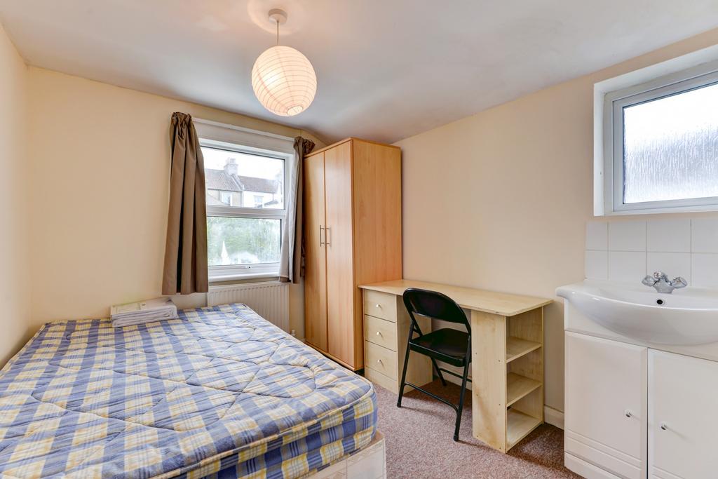 A cozy student bedroom featuring a double wardr...
