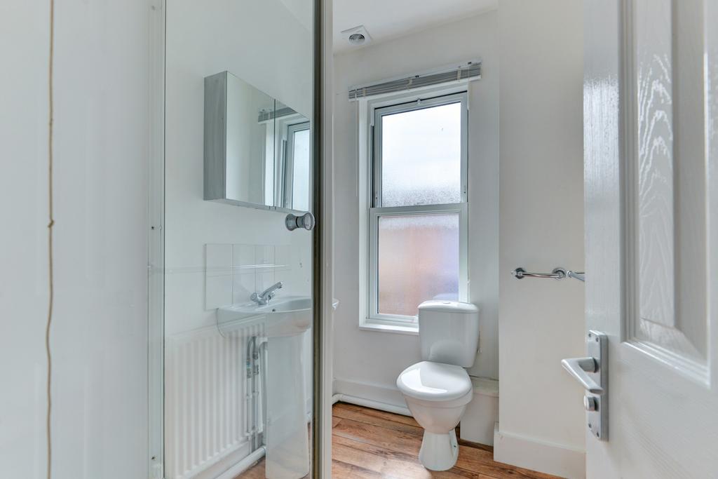 A clean and well-lit bathroom featuring a toile...