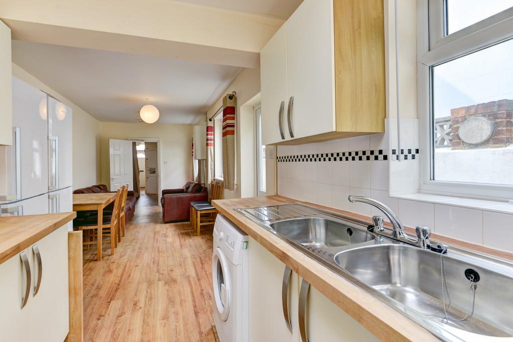 A bright and tidy kitchen featuring a double si...