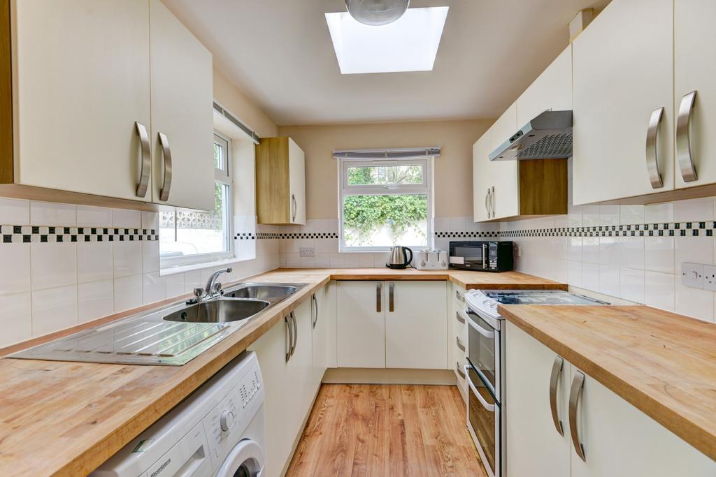Bright, modern galley kitchen with ample workto...