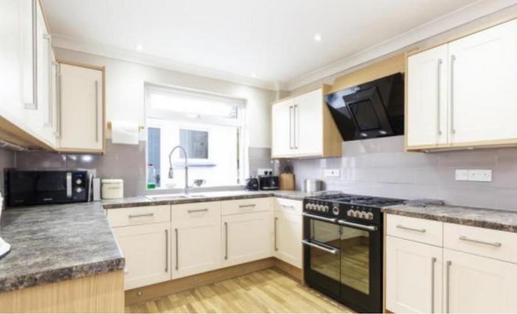 A clean and modern kitchen with ample space and...