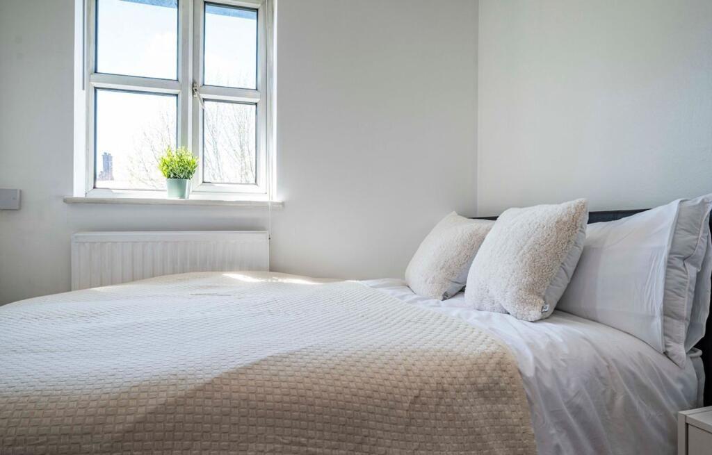 Bright, freshly styled double bedroom with a la...
