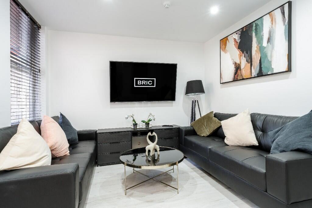 A stylish and modern living room featuring plus...