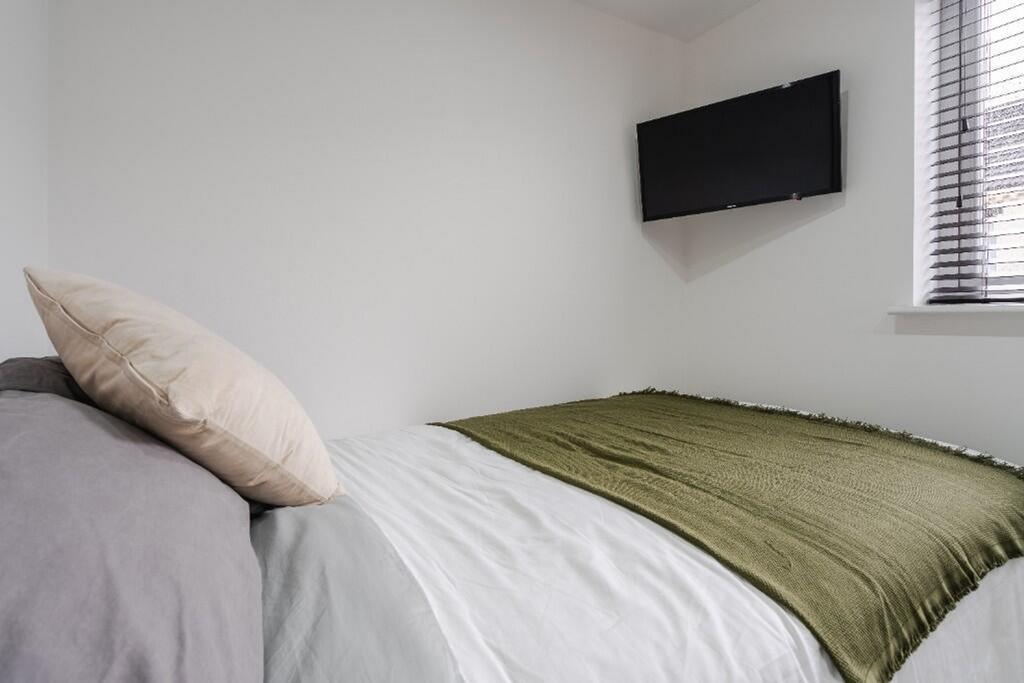 Cozy double bedroom featuring a comfortable bed...