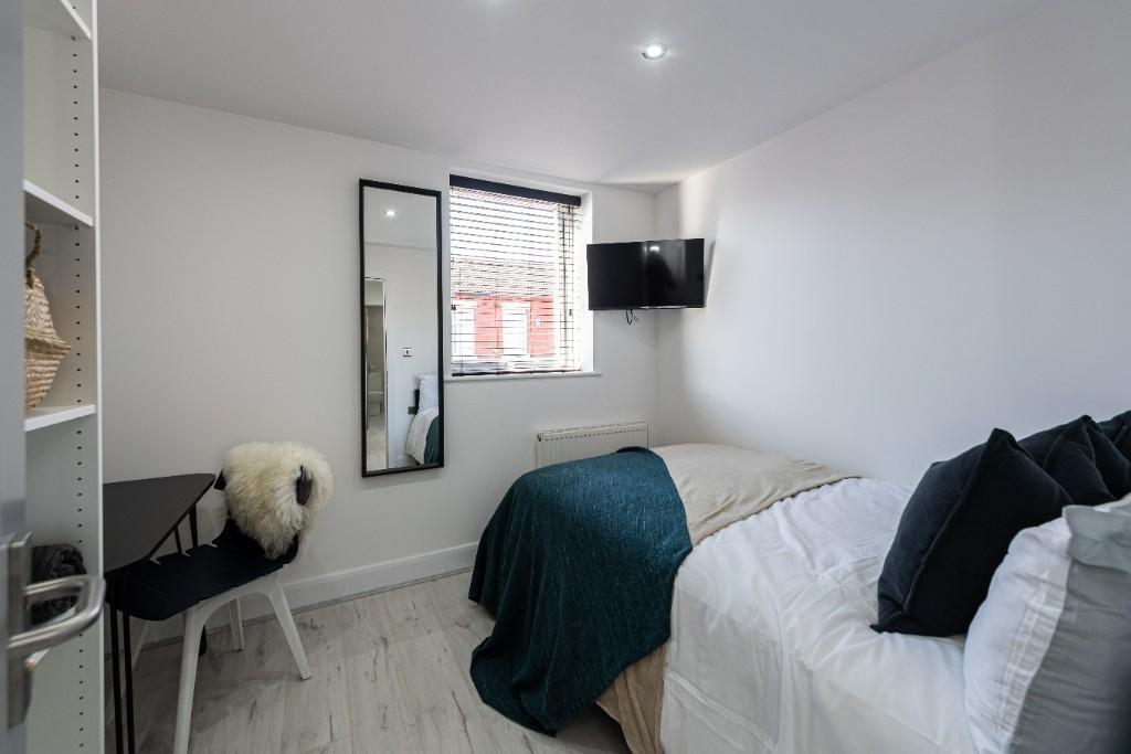 A bright and inviting master bedroom featuring ...
