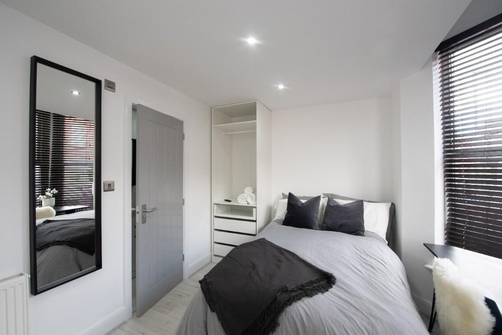 A modern and well-maintained master bedroom fea...