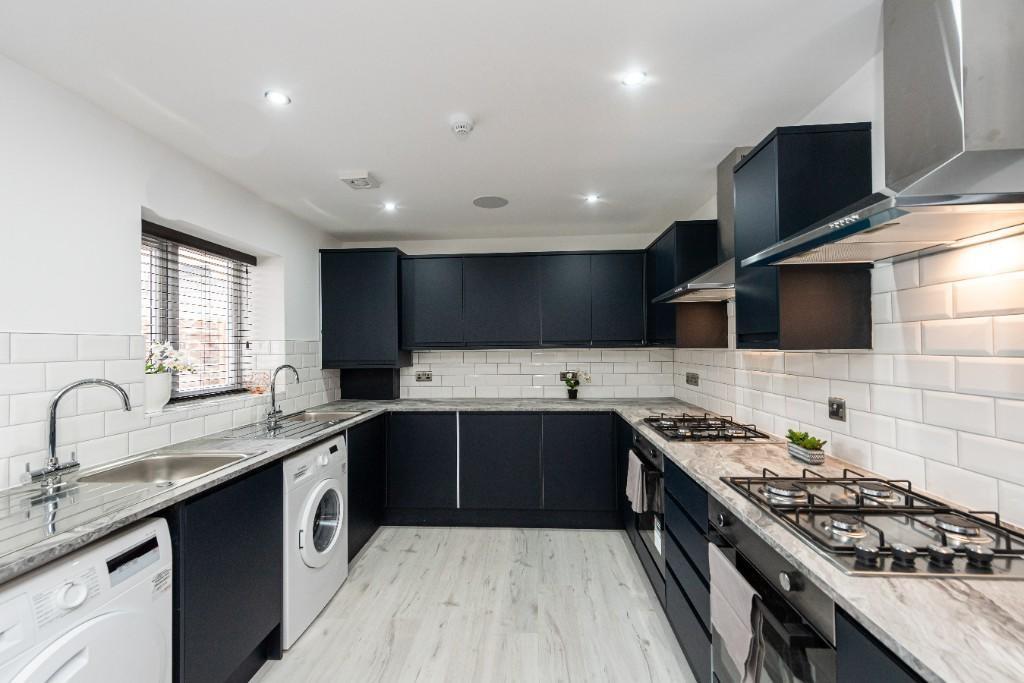 Modern and bright kitchen featuring sleek black...