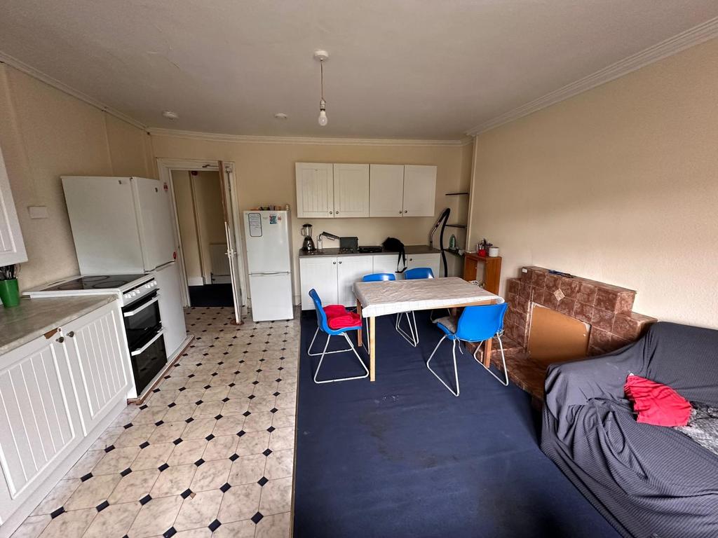 Open-plan living area with a fitted kitchenette...
