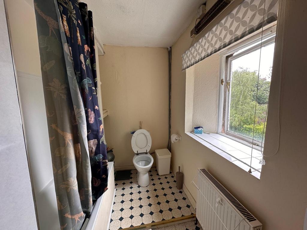 Bright bathroom with a tiled windowsill and a l...