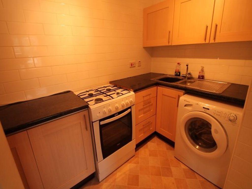 Compact fitted kitchen with freestanding oven, ...