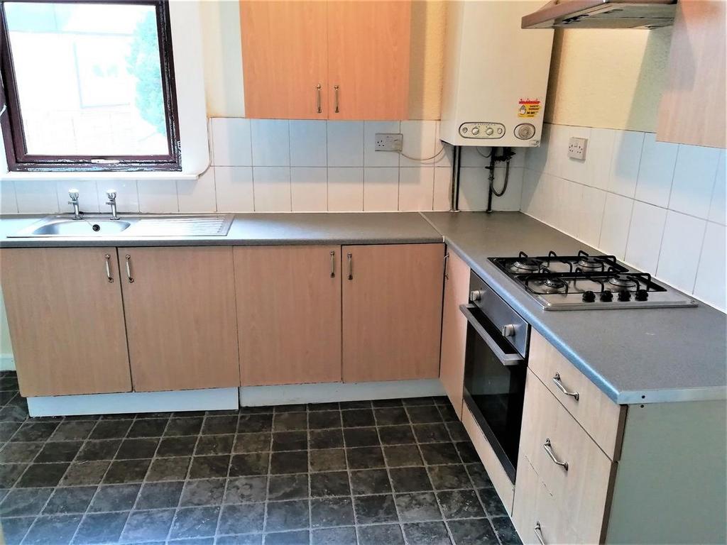 Bright kitchen with tiled splashback, fitted ca...