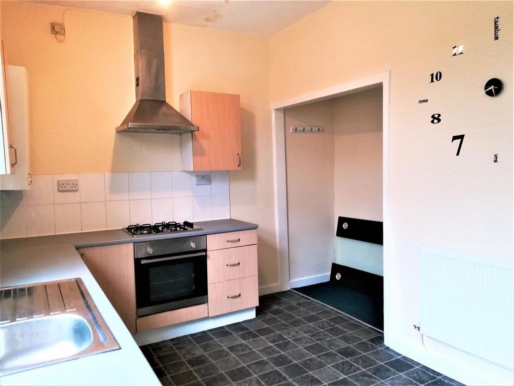 Bright kitchen with a stainless steel sink, gas...