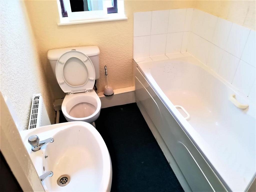 Simple bathroom with a full-size bathtub, toile...