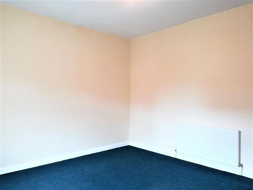 Bright, neutrally painted bedroom with clean bl...
