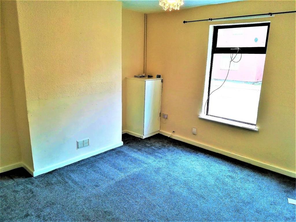 Bright bedroom with a large window, neutral dec...