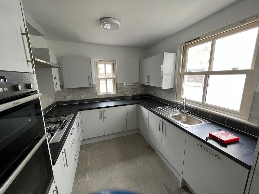 A bright and modern kitchen with ample natural ...