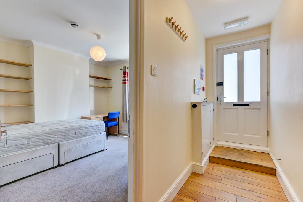 Bright, tidy bedroom with built-in shelving and...