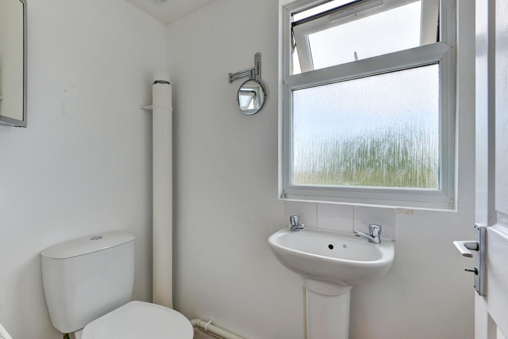 Bright, clean bathroom with frosted window, ped...