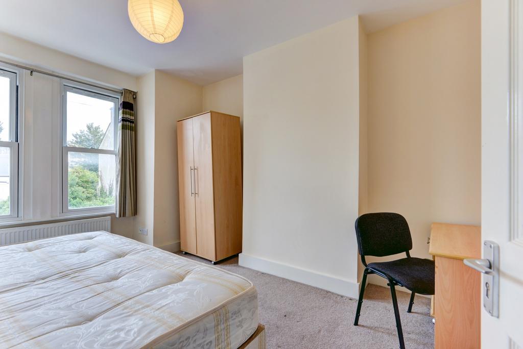A tidy bedroom featuring a double bed positione...