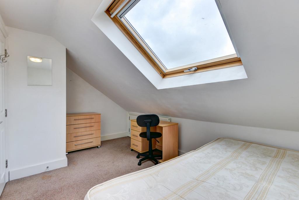 Bright attic bedroom with a skylight window let...