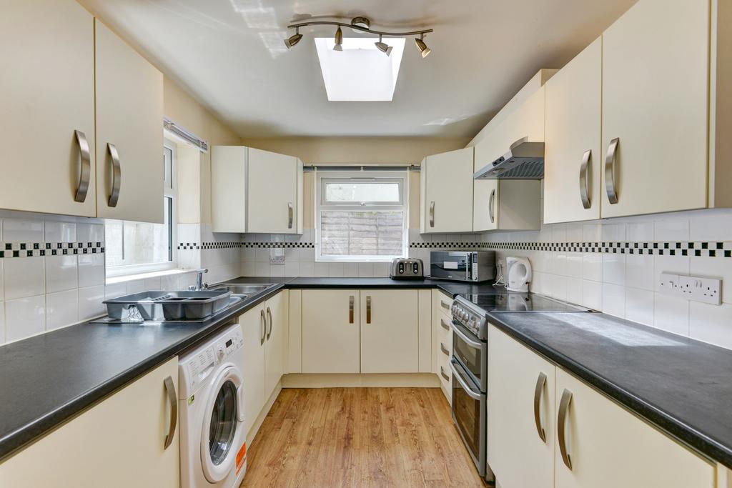 Bright, modern galley kitchen with light cabine...