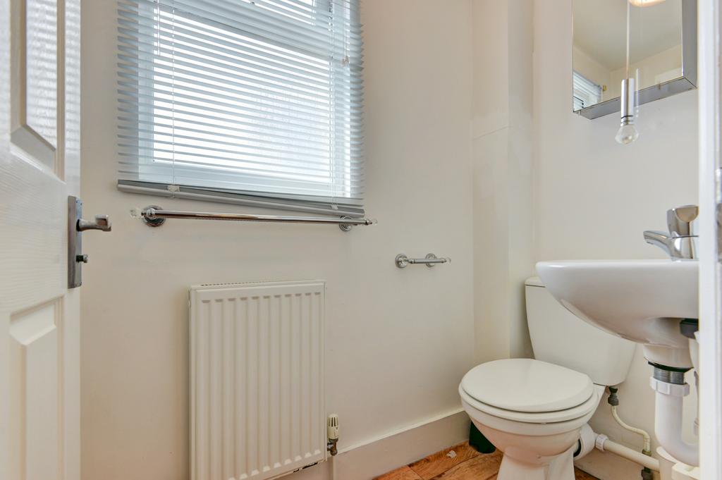 Bright, well-kept bathroom with white fittings,...