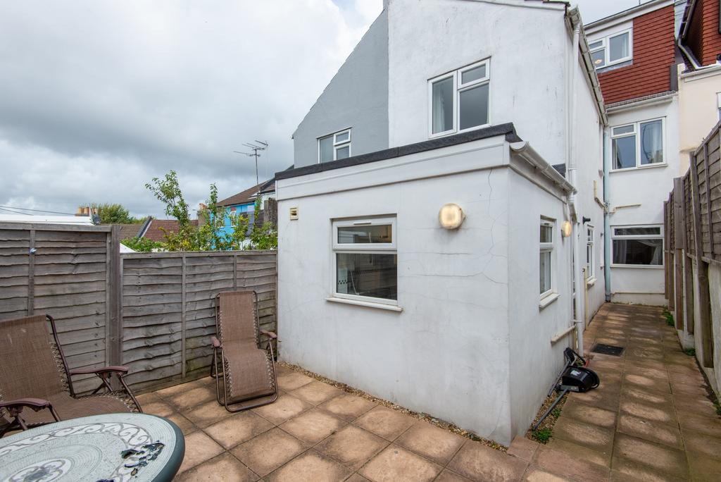 Private paved courtyard with patio seating and ...