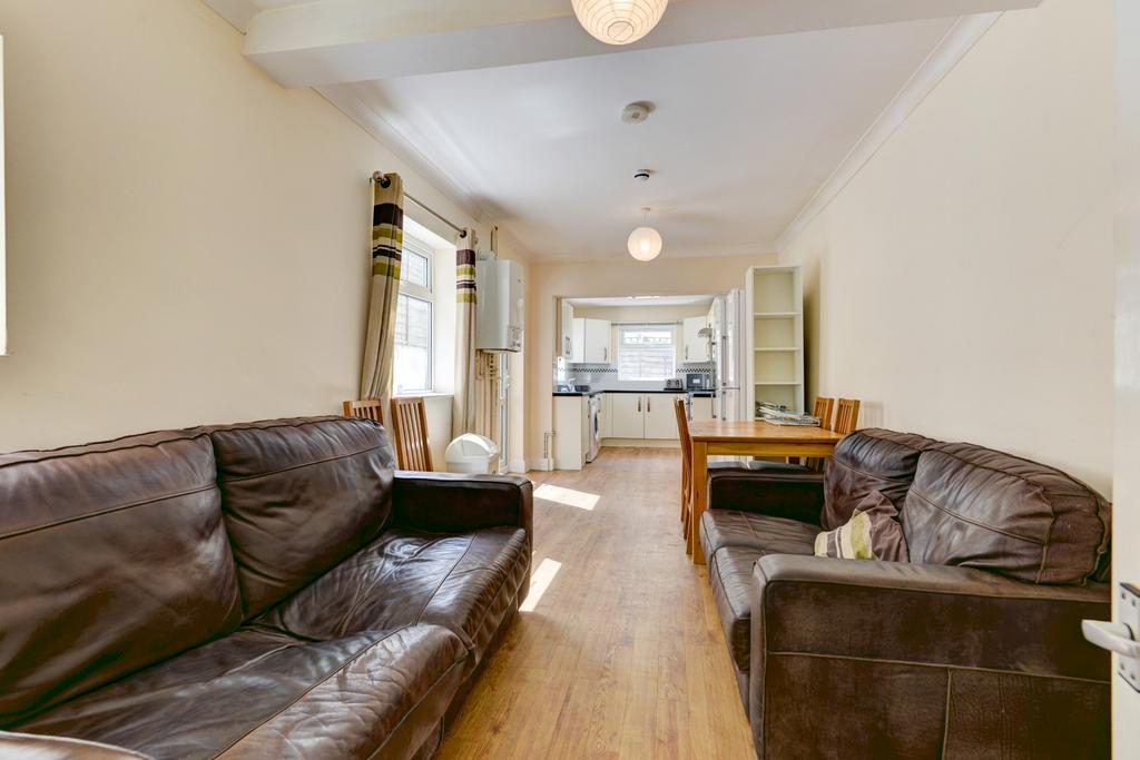 Bright, open-plan living area with wooden floor...