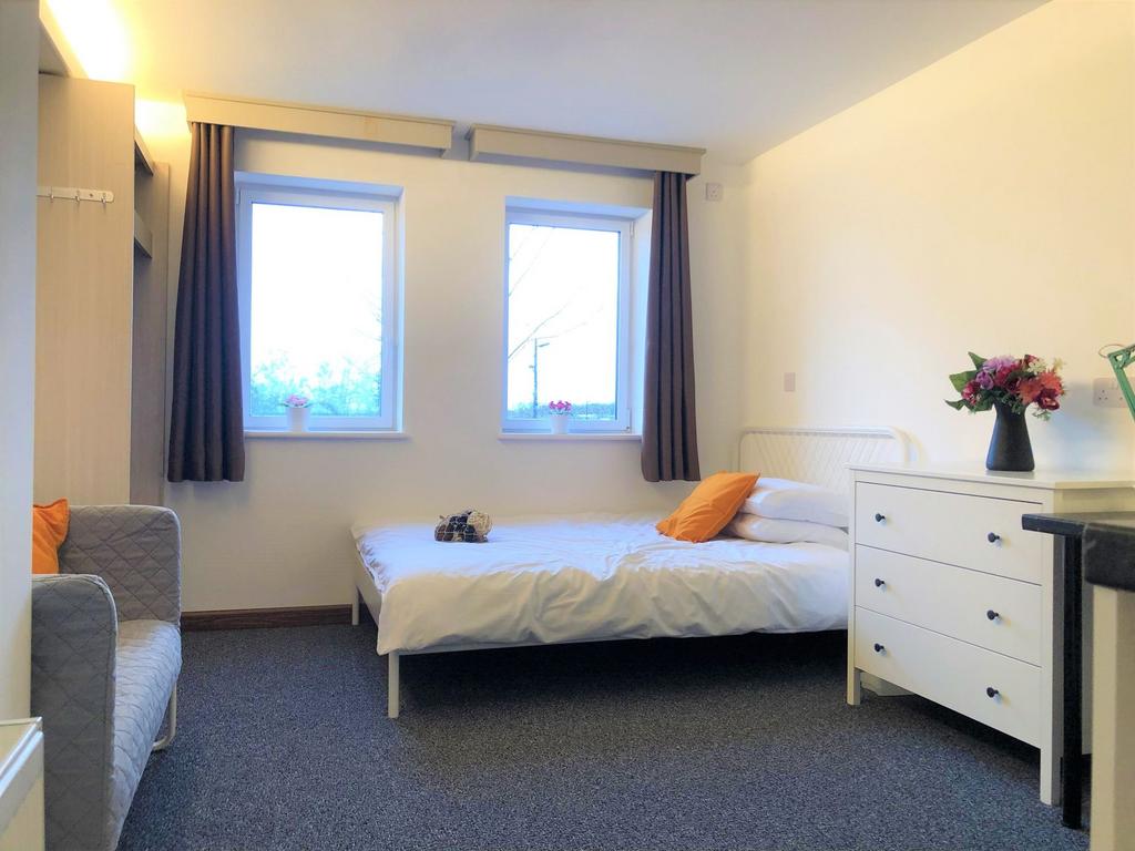 Bright and inviting double bedroom featuring tw...