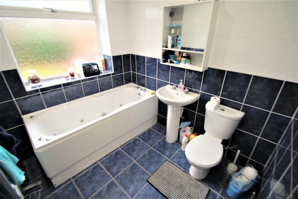 A clean and functional bathroom featuring a lar...