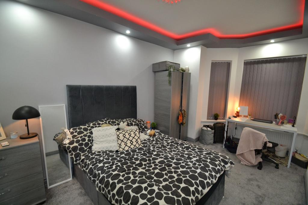Stylish master bedroom with a plush upholstered...
