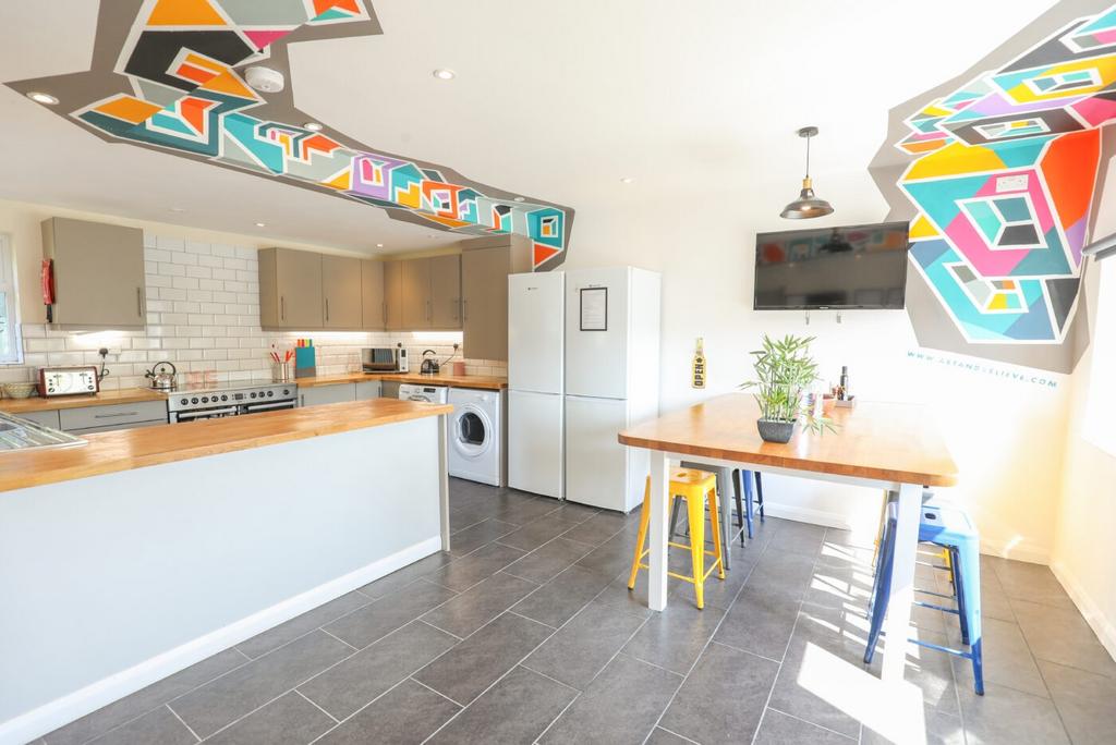Bright modern kitchen with a breakfast bar, din...