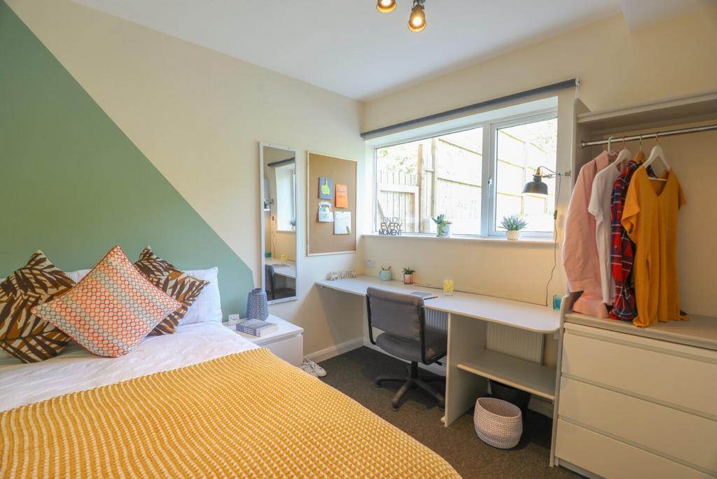Bright and welcoming bedroom with a stylish acc...