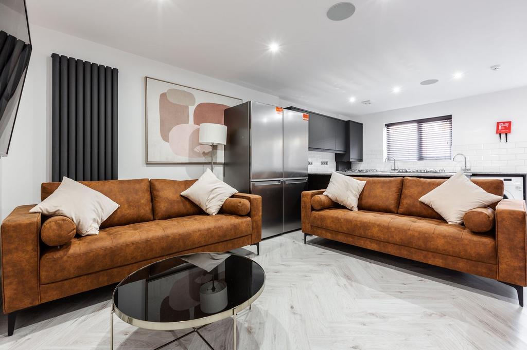 A modern and spacious living room featuring two...