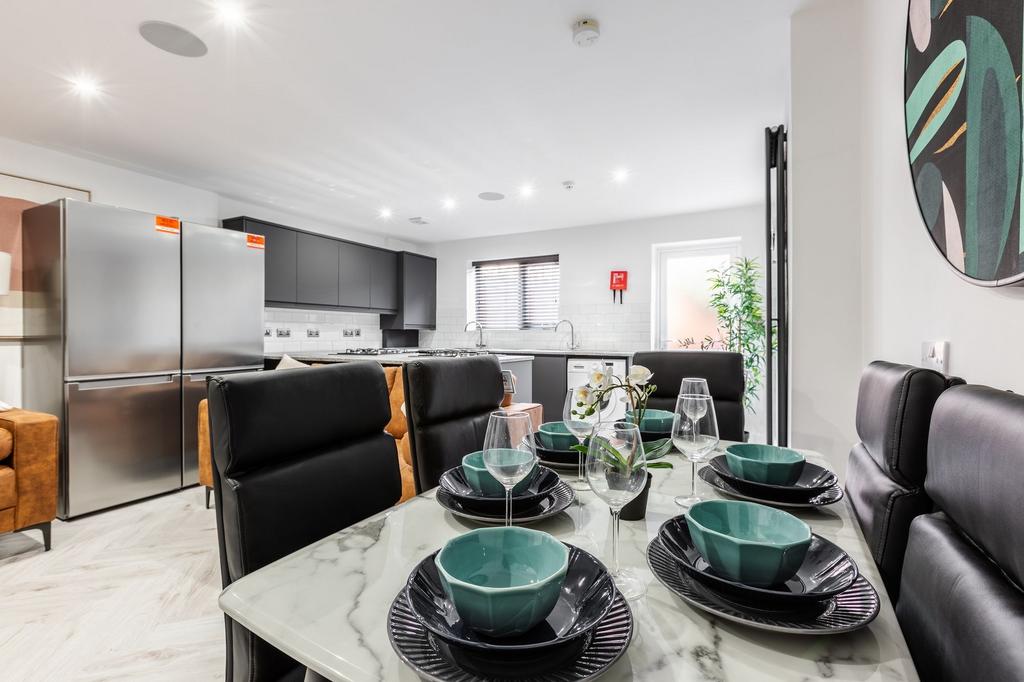 Modern, bright living space featuring a sleek k...