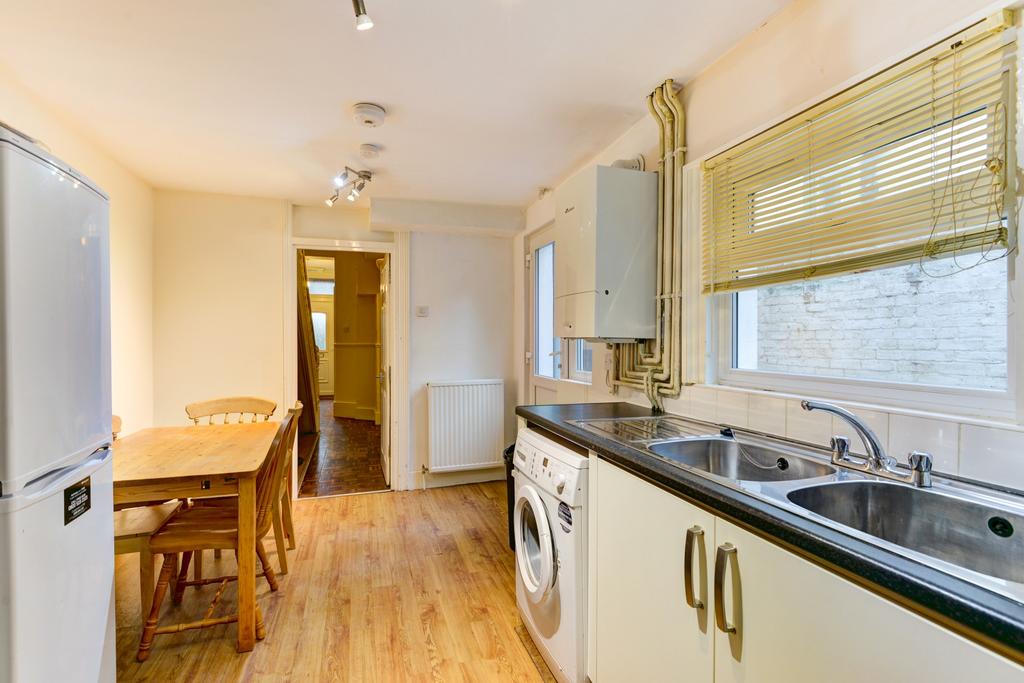Bright, neat kitchen with fitted cabinets, a la...