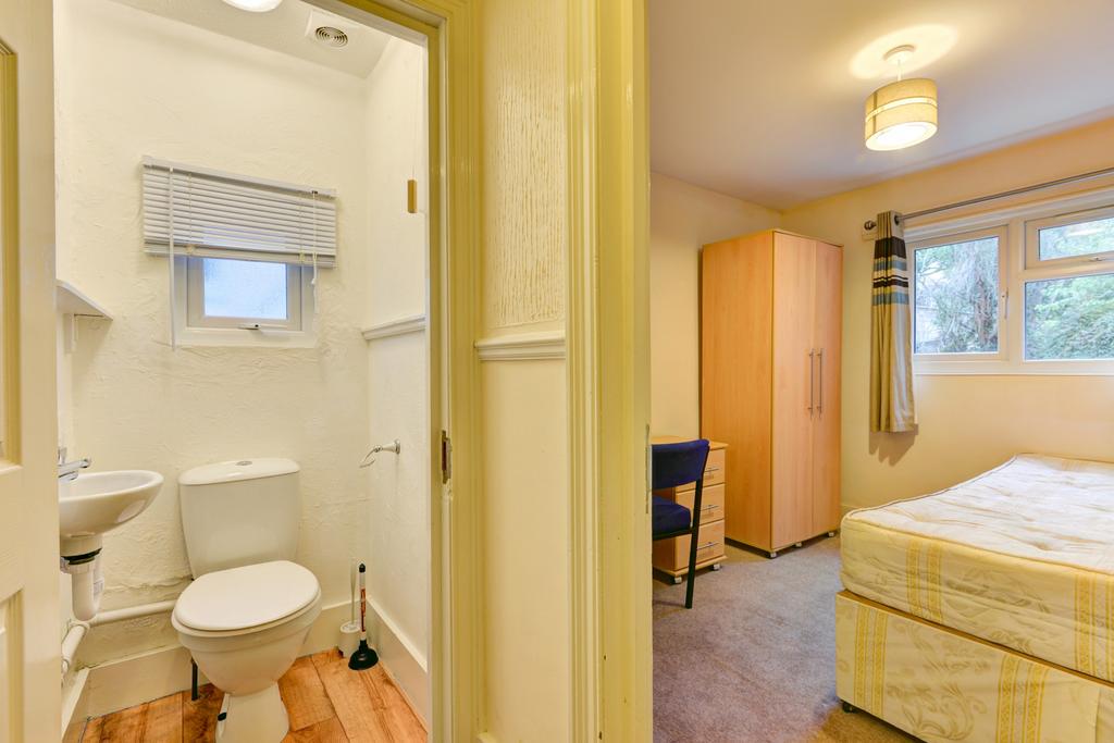 Bright and clean bathroom featuring a toilet, w...